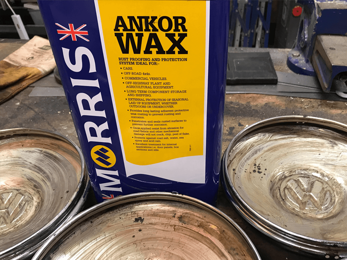 A selection of classic VW hubcaps being treated with a can of Ankor Wax