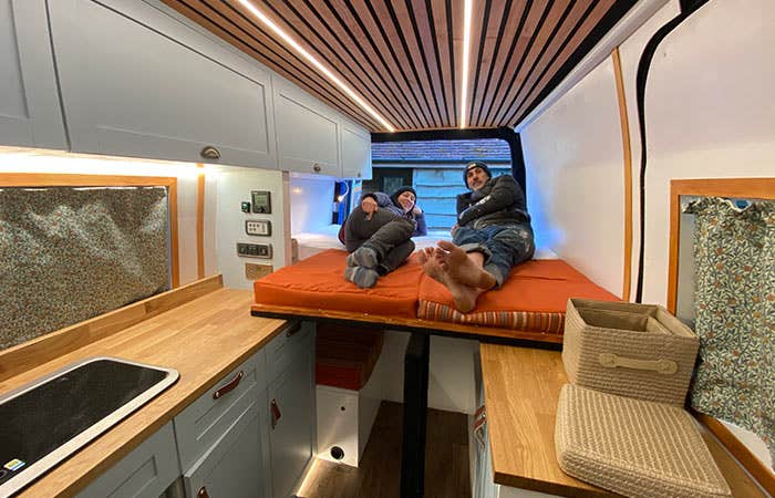 Al and Maddy posing in their newly-finished Mercedes Sprinter Campervan Conversion